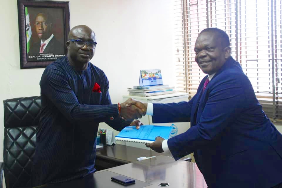 (L-R) Chief Patrick Ukah Receiving Handover Notes from Comrade Samuel Dietake, Permanent Secretary, Ministry of Basic and Secondary Education