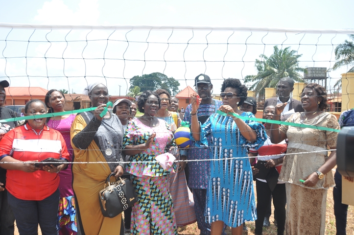 Miss Osayuwamen Aladeselu (2nd right) commissioning a volleyball court, built by beneficiaries of Federal Government's Social Investment programme, N-Power, at Eweka Primary School, Useh, in Egor Local Government Area, Edo State.