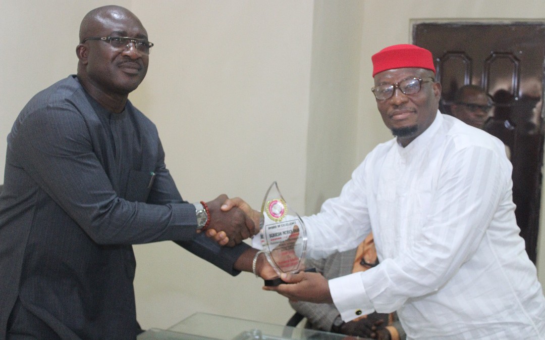 L-R: Chief Patrick Ukah receiving Award from Anioma Media Associates being Presented by the National Coordinator, Prince David Diai