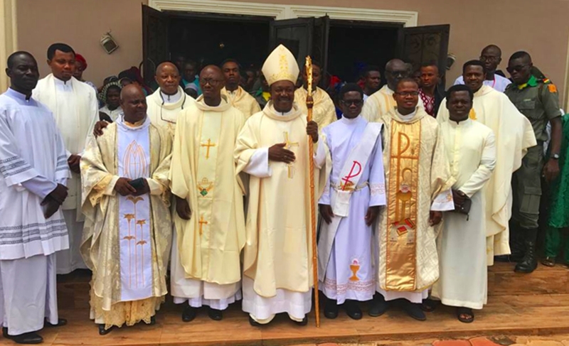 Bishop of Issele-Uku Diocese of the Catholic Communion, Most Rev. (Dr) Michael Odogwu Elue (middle), Rev. Fr. Bernard Oleru (MSP) (3rd left), Others during the Dedication of Saint Martin of Tours Catholic Church, Igbodo
