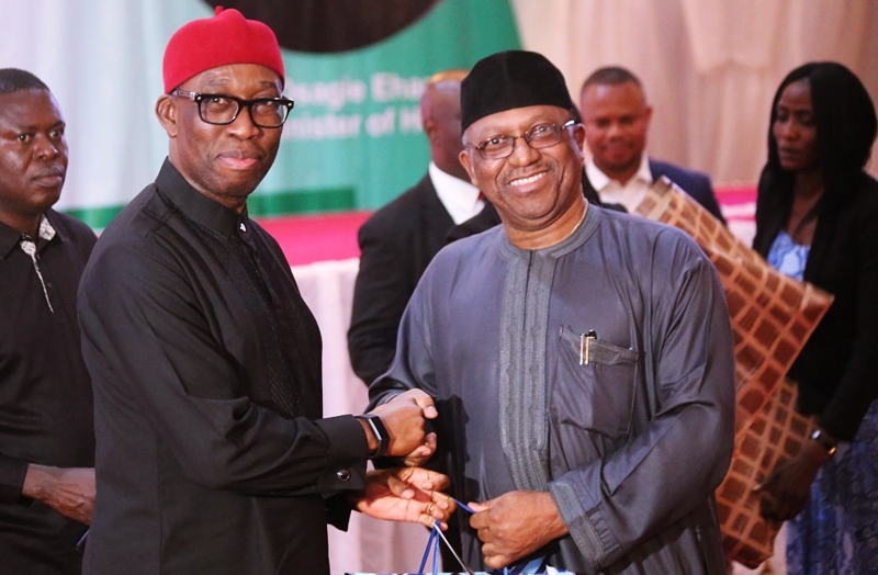 Delta State Governor, Senator Dr. Ifeanyi Okowa (left) presenting a gift to the Hon. Minister of Health Federal Republic of Nigeria, Dr. Osagie Ehanire, during the State Banquet, in Hounor of Delegates to the national Council of Health, held at Dome Event Centre Okpanam Road, Asaba Delta State.