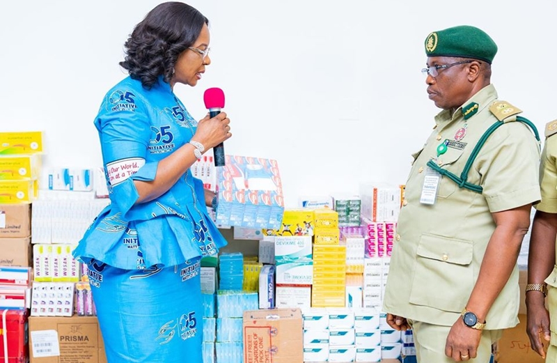 L-R: Wife of Delta Governor, Dame Edith Okowa presenting Medications meant for Inmates to the the State Controller of the Nigerian Correctional Service, Mr Sam Iyakoregha at Government House, Asaba