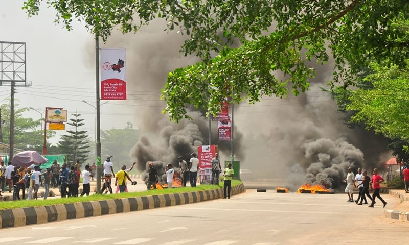 Scene of youths said to be members of the Edo State Chapter of the All Progressives Congress (APC) protesting the factionalisation of the APC in the state, in Benin City, on Thursday, December 12, 2019.