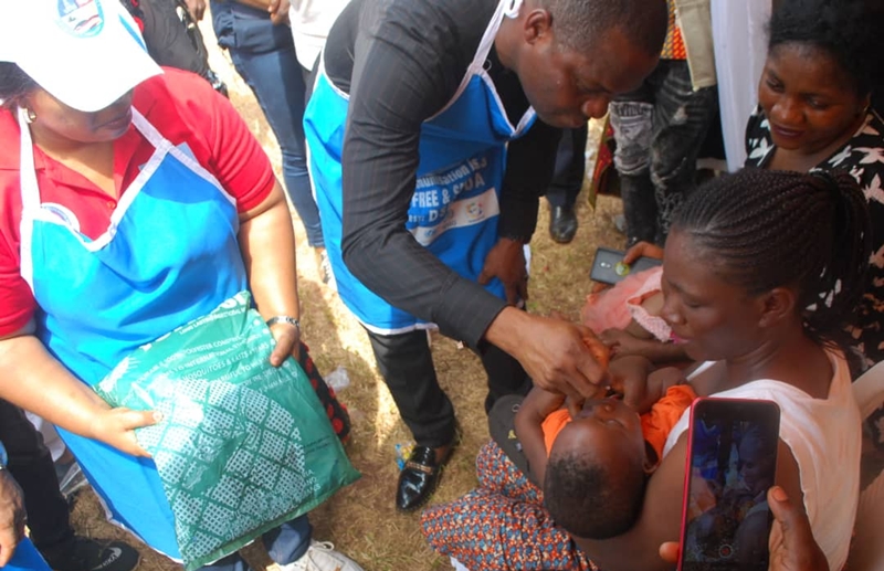 Representative of Delta Governor, Chika Ossai administering the Polio Vaccine to a Baby during the flag-Off of the Sub-National Immunization Plus Days in the State