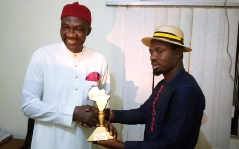 Dr. Cairo Ojougboh (left) receiving the Distinguished Personality' Award, a New Face of NDDC, from the Jet Age Nation Builder Organization