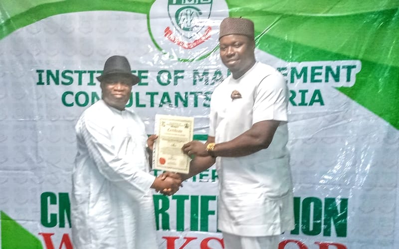 Former Minister of Education, Prof Jerry Agada (left), presenting Certificate of Fellowship to Mr. Iteveh Ekpokpobe.