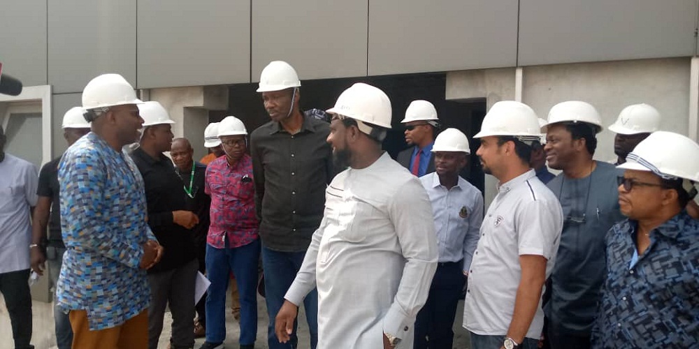 Executive Director of Projects, Dr. Cairo Ojougboh (middle) during the inspection of the NDDC Headquarters under construction