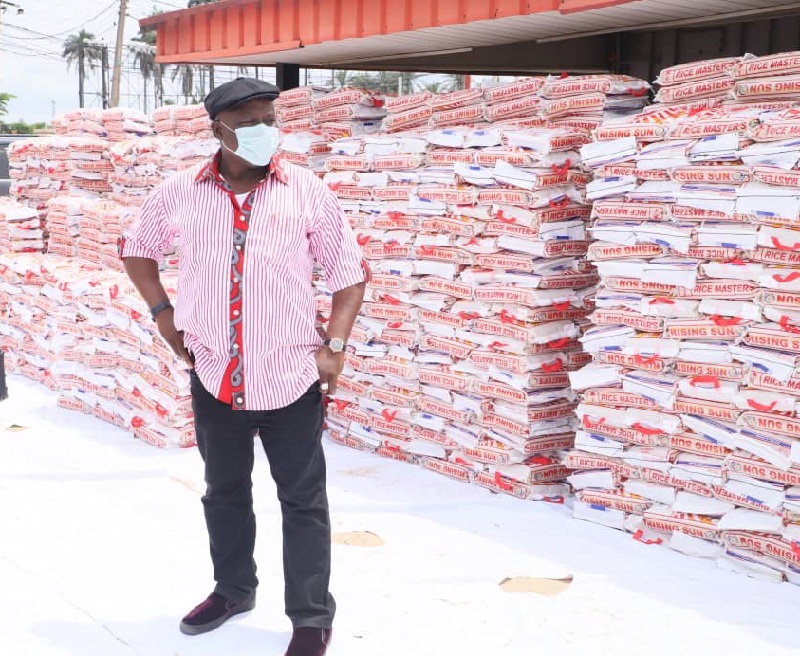 Speaker Oborevwori Standing Behind Bags of Rice He Donated to His Constituents
