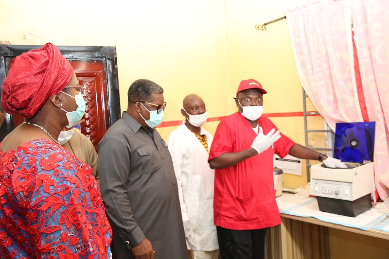 The wife of the Delta State Governor and founder O5 Initiative, Dame Edith Okowa (Left), the Commissioner of Health, Dr. Mordi Onoye (Left) listening to Dr. Clement Isibor explaining the functions of the blood screening machine at the Akwukwu-Igbo General Hospital (Pix: Norbert Amede)