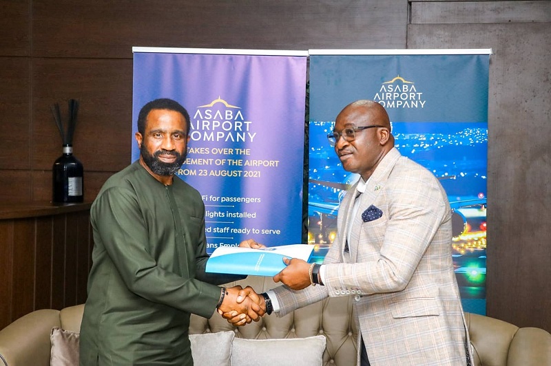 Secretary to Delta State Government, Chief Patrick Ukah (right) performing the formal handing over of Asaba International Airport to the Chairman, Asaba Airport Company, Mr. Bisi Adebutu in Asaba on Monday, August 23, 2021