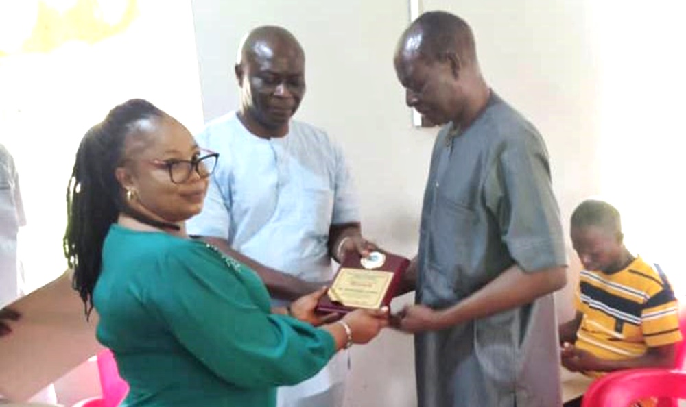 Alfred Ekpokpobe (right) Receiving the Association of Medical Laboratory Scientists of Nigeria Award
