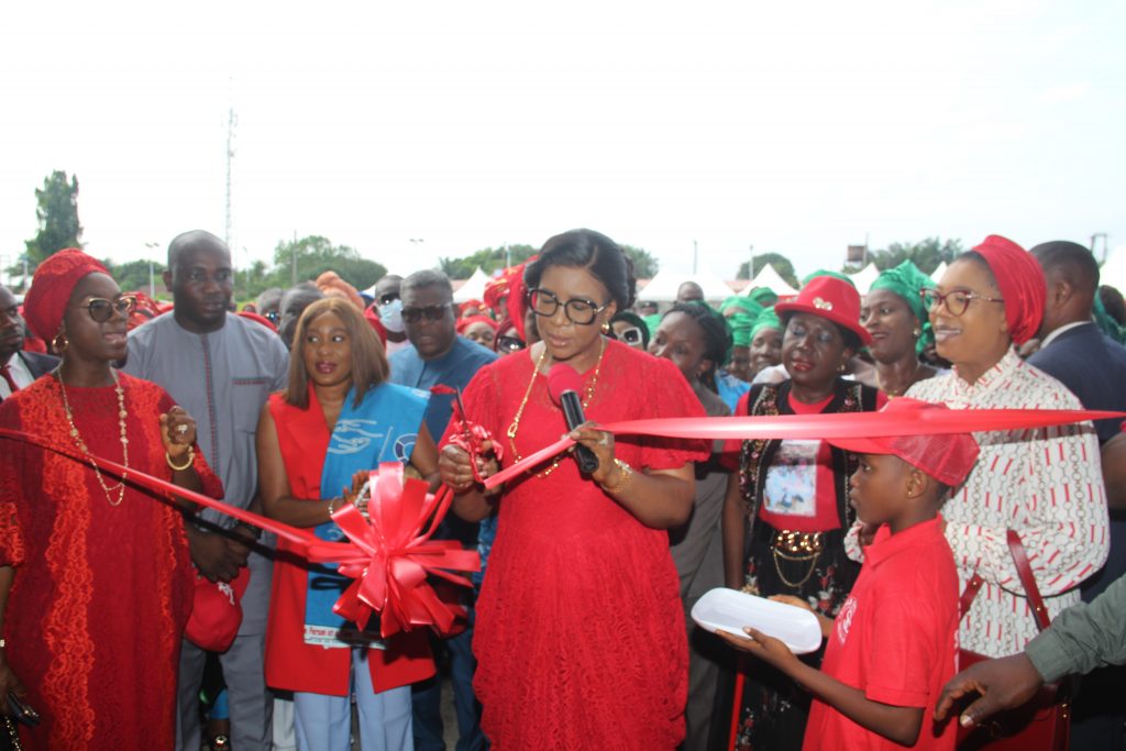 Wife of the Delta State Governor and Founder O5 Initiative, Dame Edith Okowa (Middle) cutting the tape to inaugurate the 23rd Sickle Cell Centre at the General Hospital, Obiaruku in Ukwuani Local Government Area of Delta State while Hon. Joan Onyeamechi Adanima (Right), Hon. Princess Pat Ajudah (2nd Right), the Chairman, Ukwuani Local Government Area, Hon. Barr. Possible Ajede (2nd Left), his wife Mrs. Ajede and Mrs. Ruth Osiegbu watch (PIX: NORBERT AMEDE)