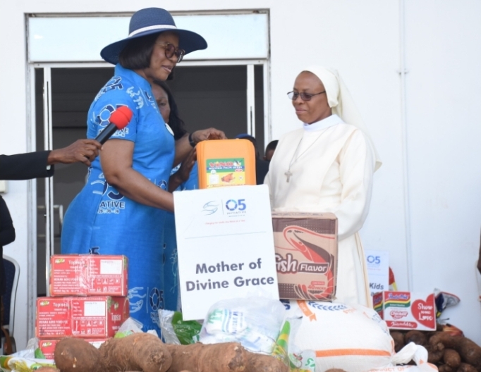 The wife of the Delta State Governor and Founder O5 Initiative, Dame Edith Okowa (Left) presenting food items to Rev. Sister Stella Maris Edet of mother of Devine Grace Orphanage, Asaba during the 2022 world Orphans day celebrations held in Government House Asaba PIX:NORBERT AMEDE