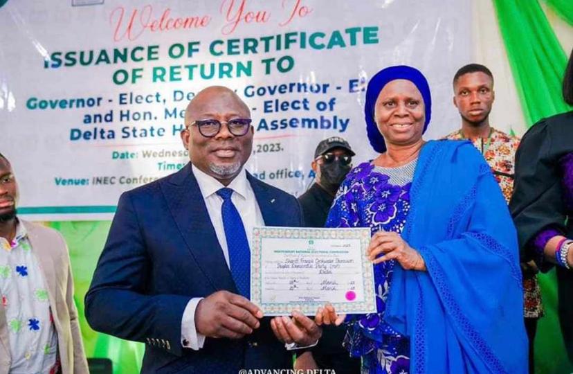 L-R: Rt. Hon. Sheriff Oborevwori receives his Certificate of Return as Governor-elect of Delta State from Mrs Roda Gumus, National Electoral Commissioner in charge of Bayelsa, Delta and Edo states.