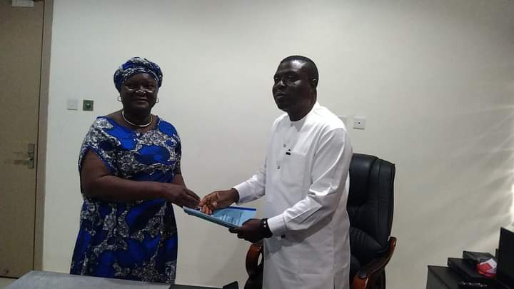Delta Commissioner for Trade and Investment Hon Samuel Oligida receiving handover notes from the Permanent Secretary.