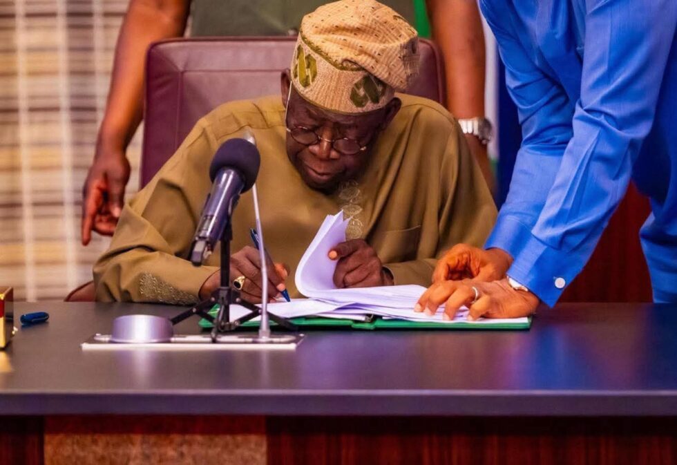President Bola Tinubu signs a Document. (File Photo