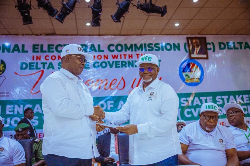Deputy Governor, Delta State, Sir Monday Onyeme (left), who represented Governor Sheriff Oborevwori receiving a copy of an address from the Resident Electoral Commissioner (REC), Independent National Electoral Commission (INEC), Delta State, Sir Etekamba Umoren, during a Sensitization Engagement of Delta State Stakeholders on the continuous voter registration exercise in Government House, Asaba on Wednesday, January 21, 2025