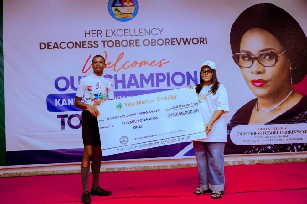 Wife of the Governor of Delta State, Deaconess Tobore Oborevwori (left) presenting a cheque of N10,000,000 (Ten Million Naira) to Master Kanyeyachukwu Tagbo-Okeke as support for his cycling awareness campaign on Autism from Enugu to Lagos at Government Asaba, on Sunday, March 22, 2026.