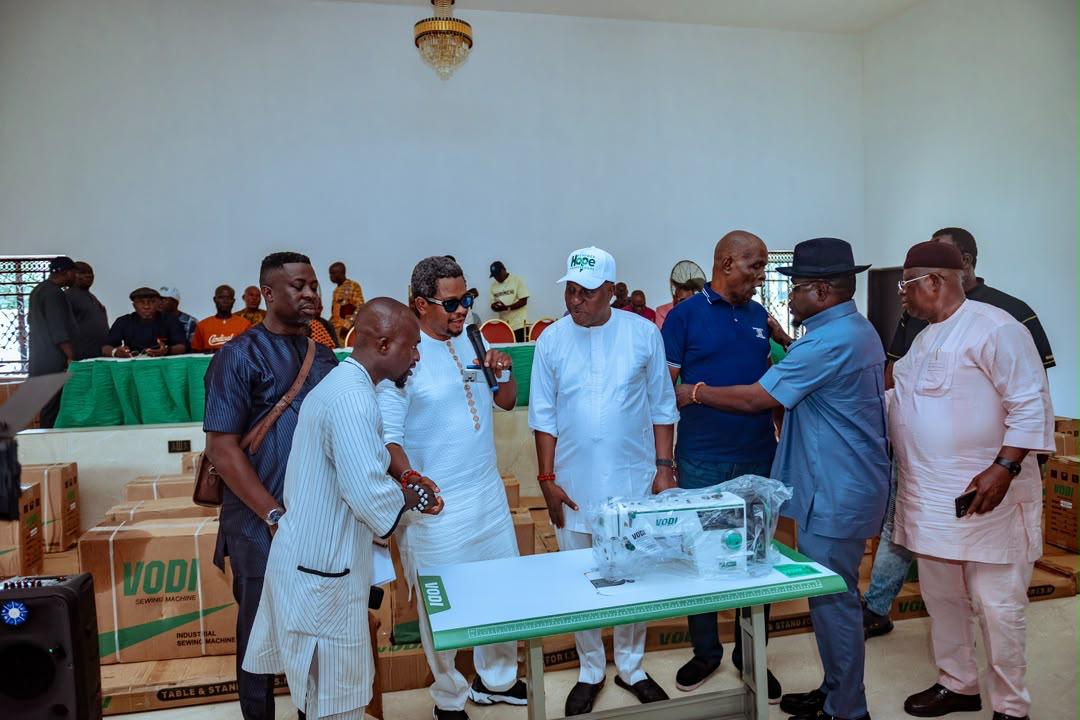 DESOPADEC ED Chief Oghenekome Okpobor (with microphone) presenting sewing machines to beneficiaries in Iyede, Isoko North.