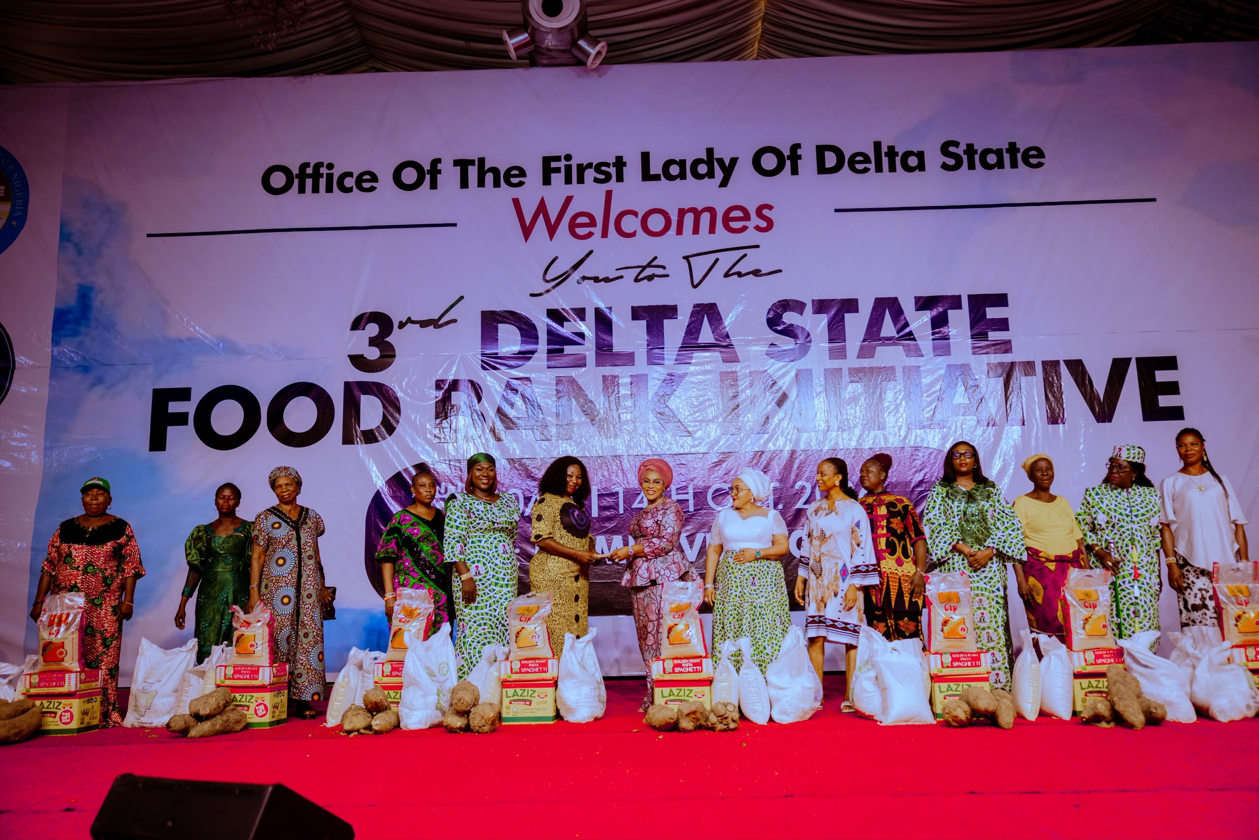 The Wife of the Delta State Governor and Founder, You Matter Charity Foundation, Deaconess Tobore Oborevwori (7th left), presenting cash gifts and food items to a beneficiaries during the distribution of food items to 2,500 women across the 25 Local Government Areas of the state under the 3rd Delta State Food Bank Initiative, sponsored by the Office of the First Lady, at the Event Centre in Asaba on Wednesday, October 14, 2026, while the wife of the Deputy Governor, Ezinne Catherine Onyeme (8th left); Commissioner for Women Affairs, Hon. Pat Ajudua (2nd right); and others look on.